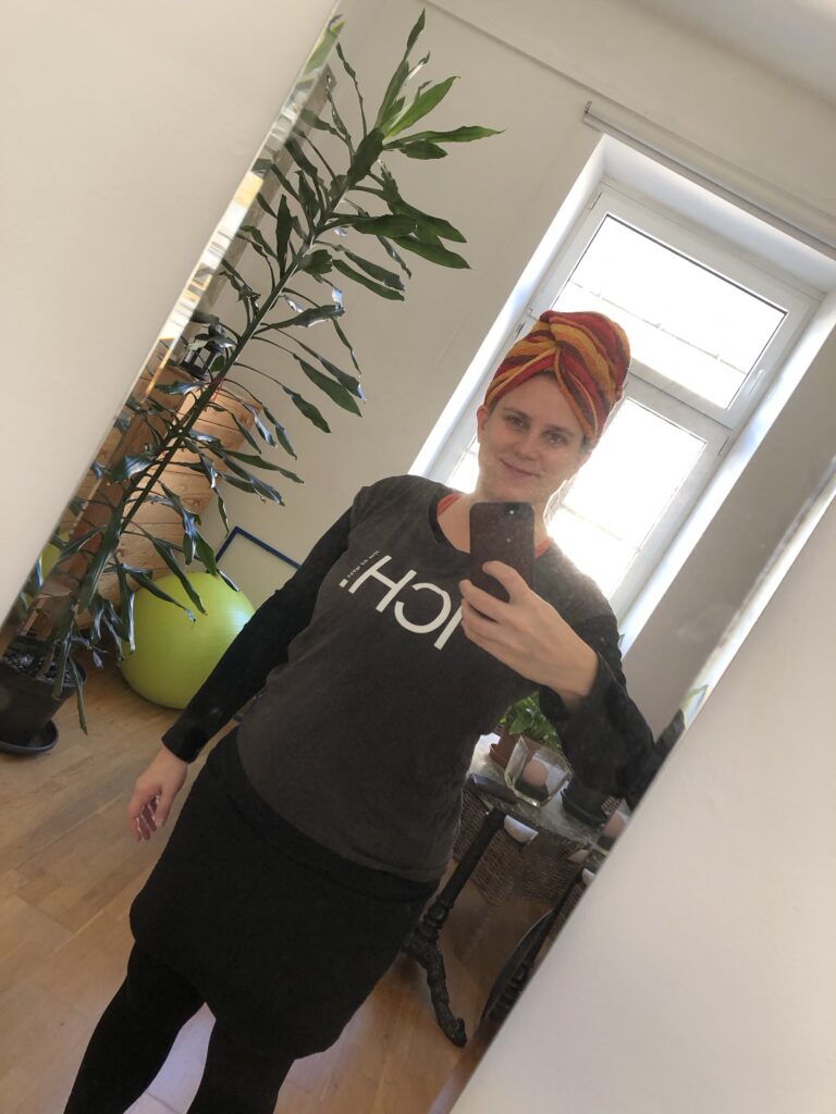 Ein Selfie in den Spiegel hineinfotografiert, das Foto ist schräg nach rechts gekippt und zeigt mich mit Handtuch auf dem Kopf.